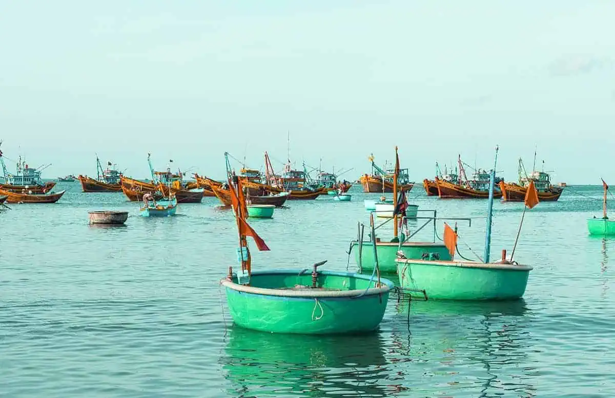 Is Mui Ne Worth Visiting & BEST Mui Ne Itinerary (2025) 12 local style fishing boats at sea in the fishing village in mui ne