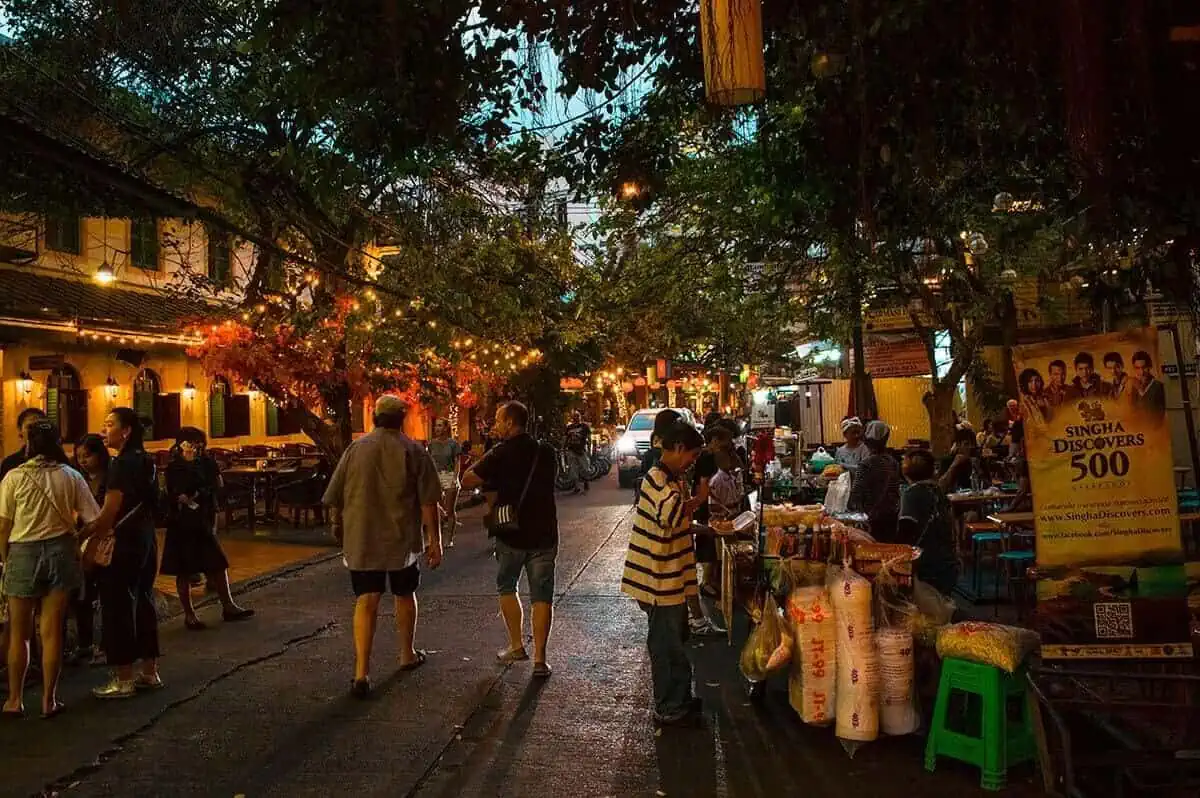 Bangkok To Chiang Mai: Bus, Train, Or Fly? 4 people walking down khao san road in bangkok