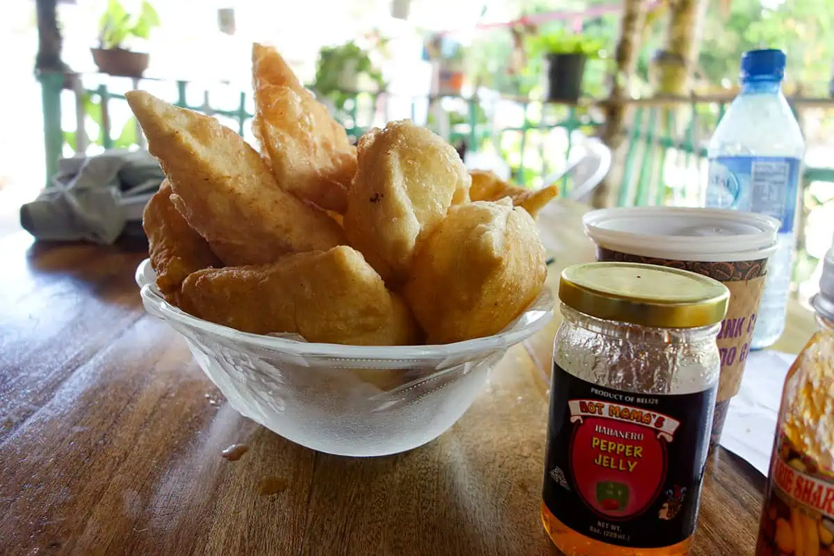 Best Belizean Breakfast To Try On Your Holiday 2 A Belizean breakfast of crispy fry jacks served with a jar of habanero pepper jelly, setting the scene for a traditional morning meal in Belize.