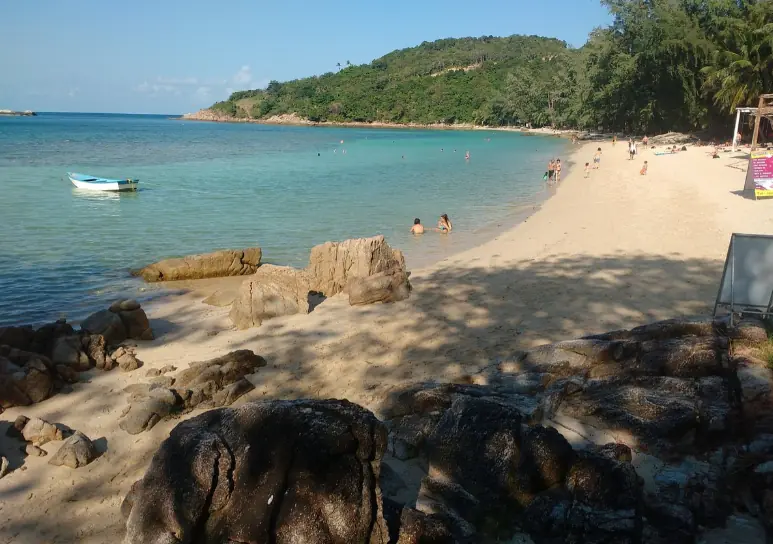 swimmers enjoying the shallows at haad khom beach in koh phangan