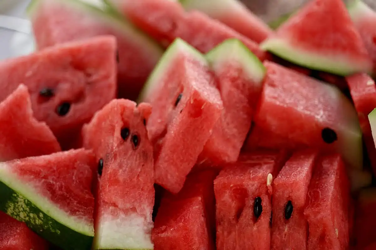 Fruits In Belize: The BEST 24 Fruits Worth Trying On Your Visit 10 Slices of juicy red watermelon arranged with precision, showcasing the refreshing summer fruit with black seeds.