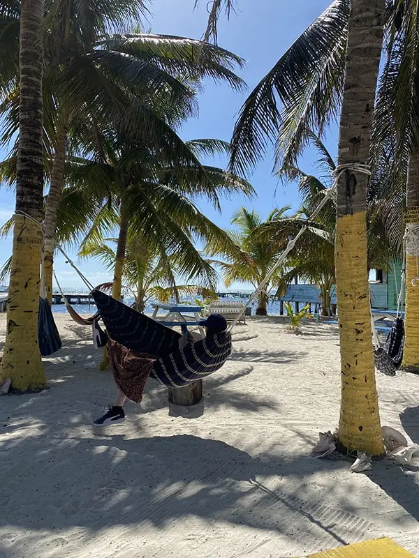 relaxing in a hammock on a beach in caye caulker