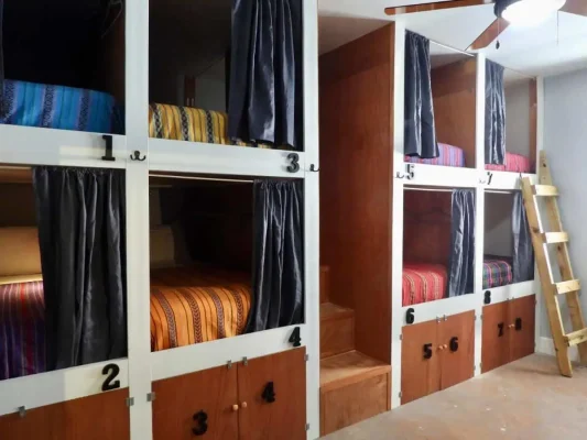 pod style bunk beds in the dorm room at sandbar beachfront hostel, one of the best hostels in belize
