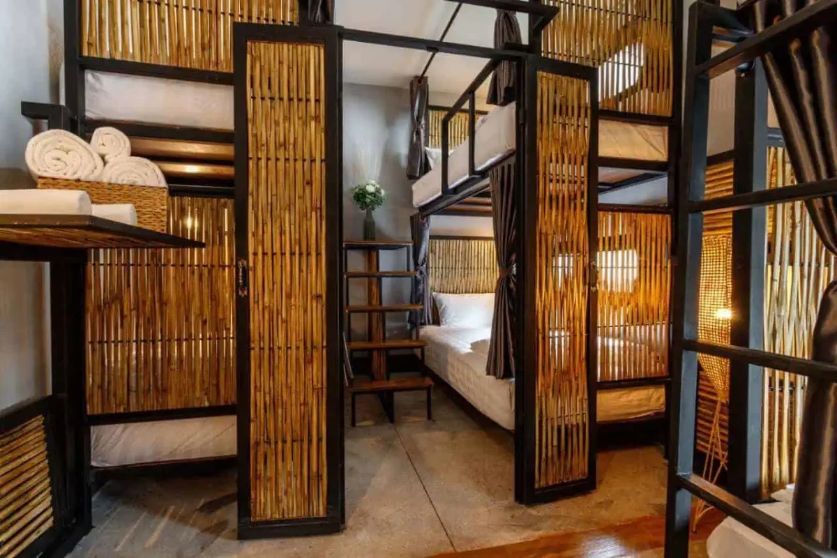 21 Best Hostels In Chiang Mai: Find Your Budget Stay 2025 5 bamboo framed bunk beds with privacy curtains at hostel one art and gallery