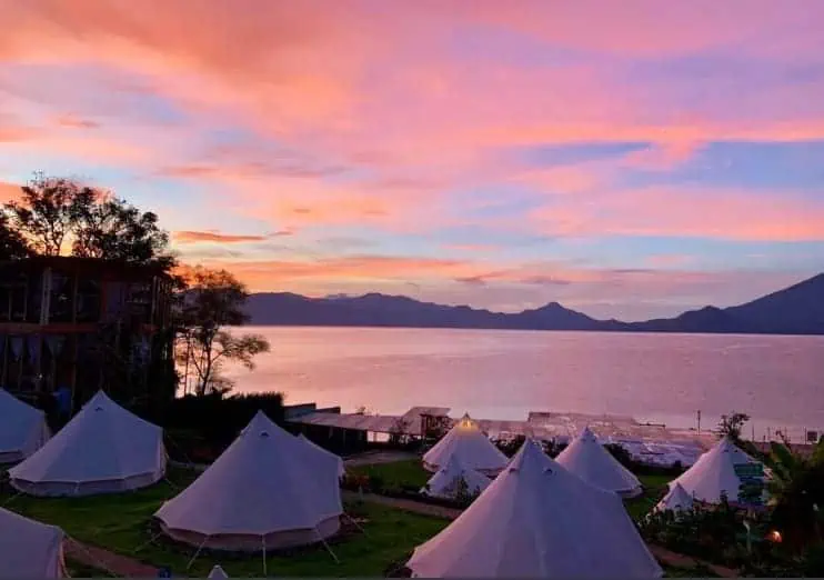The 8 BEST Hostels In Lake Atitlan: My Favorites (2025) 8 enjoying sunset over the glamping tents which are the shared dorms at free cerveza hostel in lake atitlan