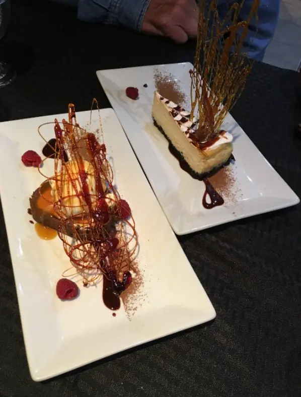 12 Best Restaurants In San Ignacio: Top Eats For Visitors 14 An elegant dessert presentation featuring a slice of cheesecake with a caramel spiral decoration, showcasing the culinary creativity found in San Ignacio, from crave house of flavors