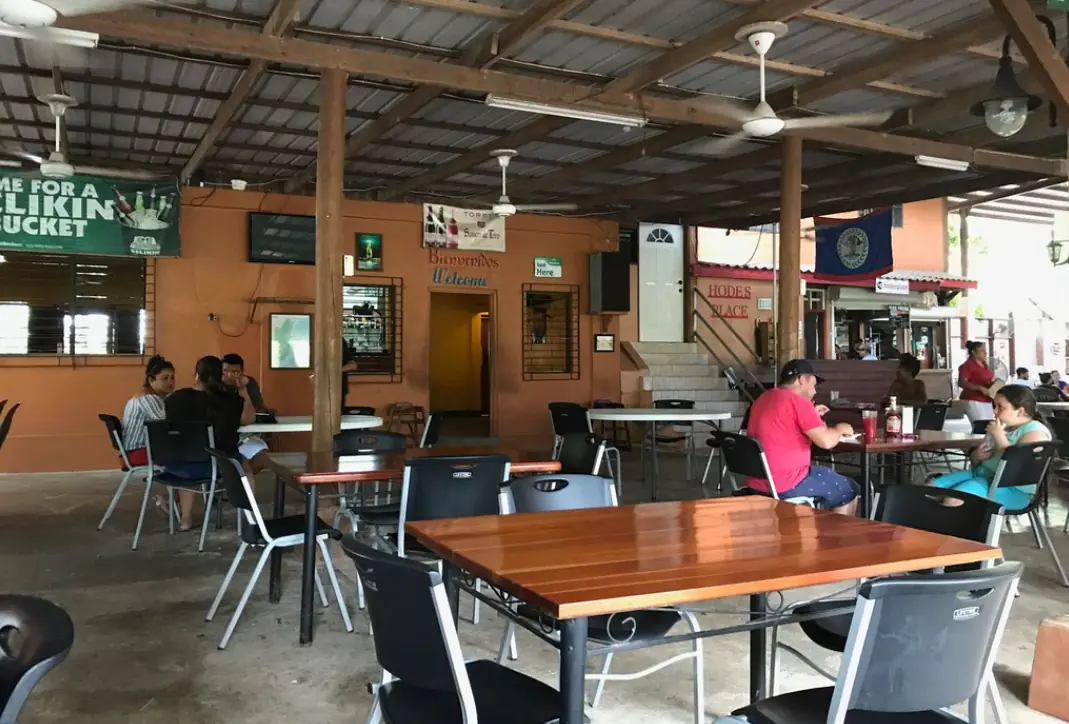12 Best Restaurants In San Ignacio: Top Eats For Visitors 15 Open-air dining area with simple furniture and a welcoming vibe at hodes place, one of the many comfortable spots to grab a bite in San Ignacio.