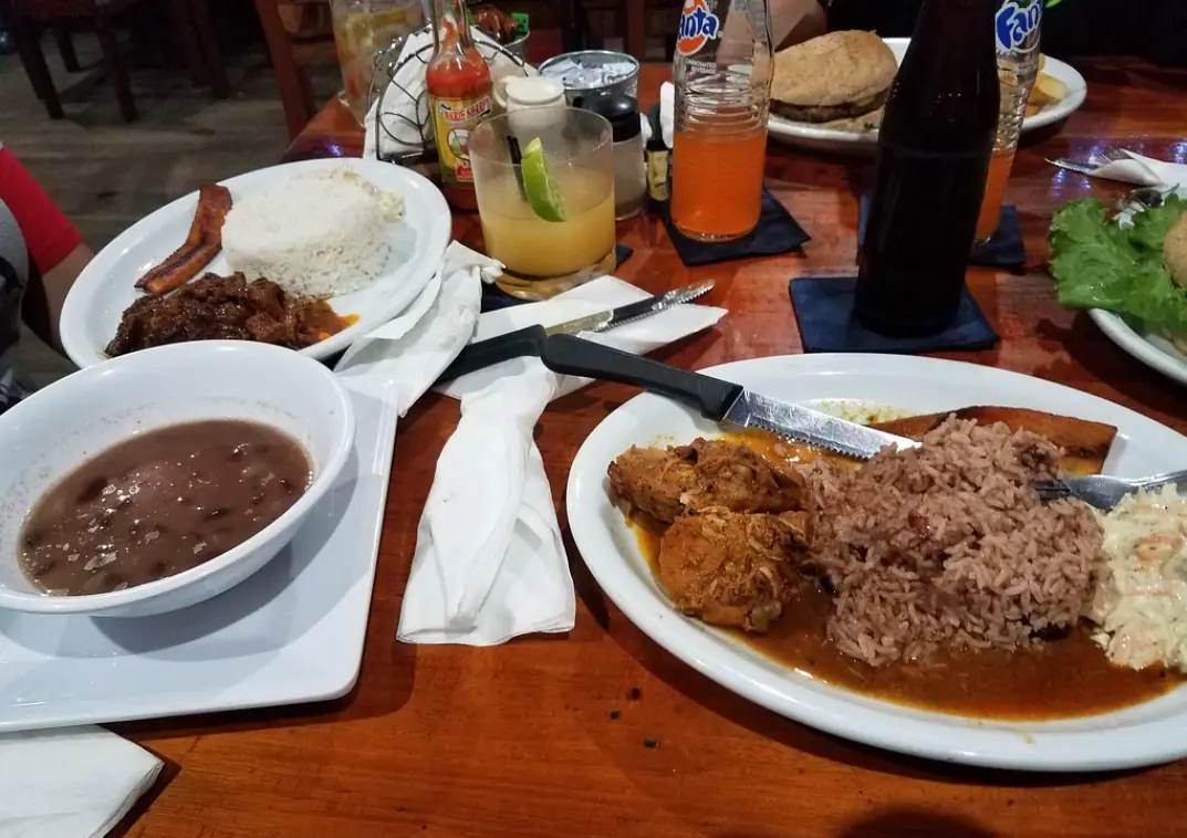 12 Best Restaurants In San Ignacio: Top Eats For Visitors 10 A traditional Belizean meal with stewed meat, rice, beans, and fried plantain, served with refreshing beverages, at ko-ox han nah, a popular eatery in San Ignacio.