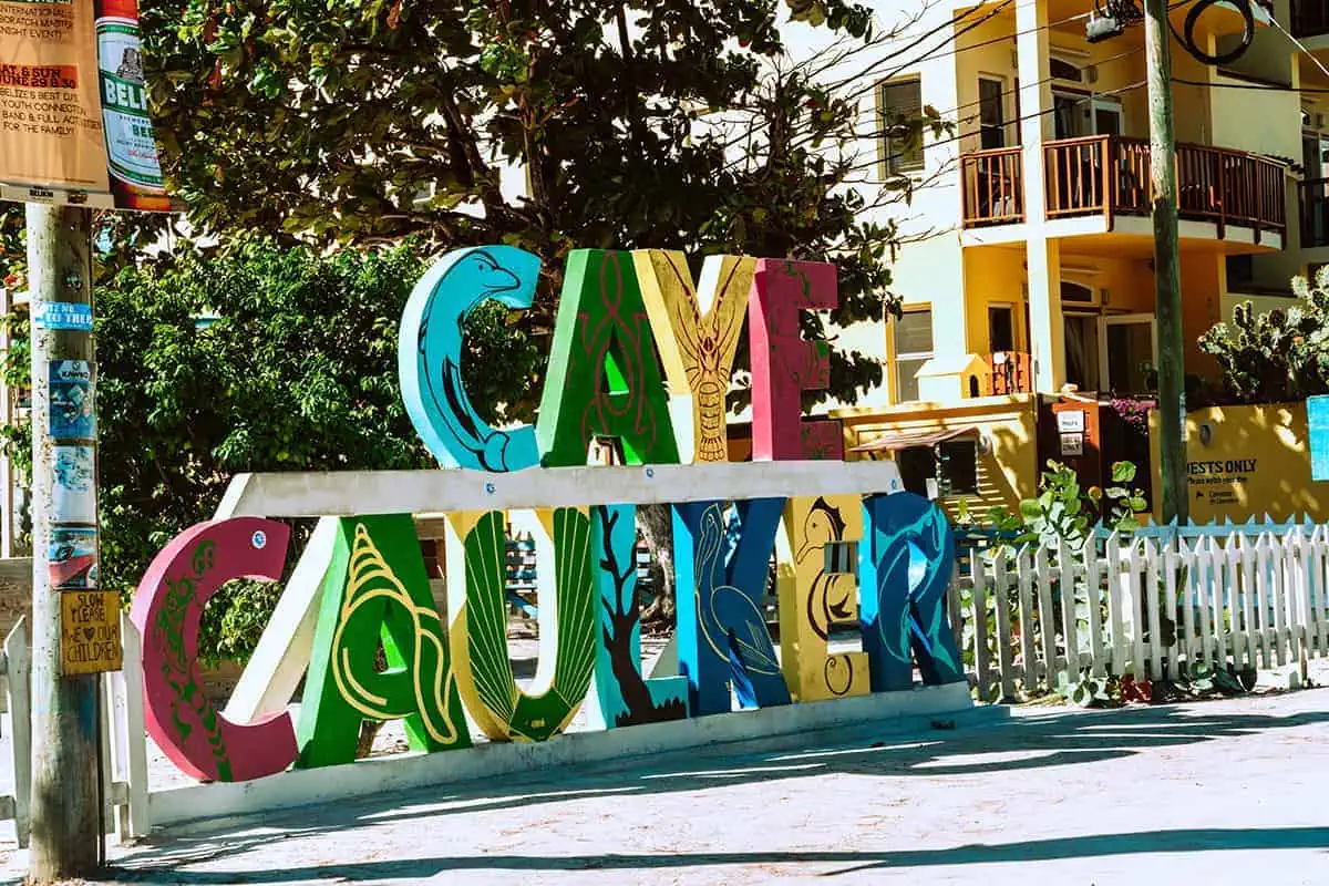 The 31 BEST Things To Do In Caye Caulker: Ultimate List! 23 A colorful sign welcoming visitors to Caye Caulker, with each letter decorated in vibrant, tropical designs. The sign is located in a charming area with trees and buildings in the background, creating a festive and inviting atmosphere. Taking photos with the Caye Caulker sign is one of the best things to do in Caye Caulker.