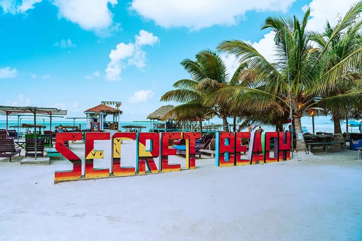 41 Best Things To Do In Ambergris Caye For The Ultimate Holiday 7 The iconic "Secret Beach" sign at Ambergris Caye, colorful and vibrant, inviting visitors to explore one of the island's most beloved hidden gems.