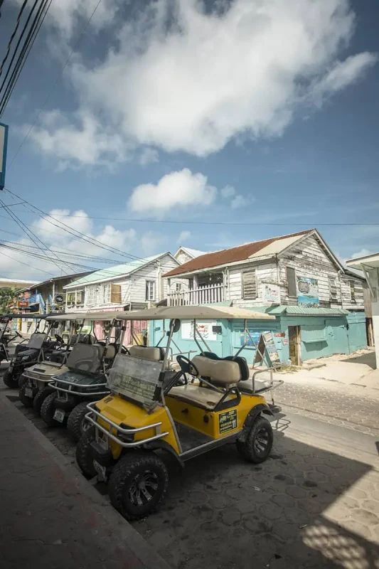 41 Best Things To Do In Ambergris Caye For The Ultimate Holiday 17 Golf carts parked along a sandy road in Ambergris Caye, indicative of the primary mode of transportation for locals and tourists alike.