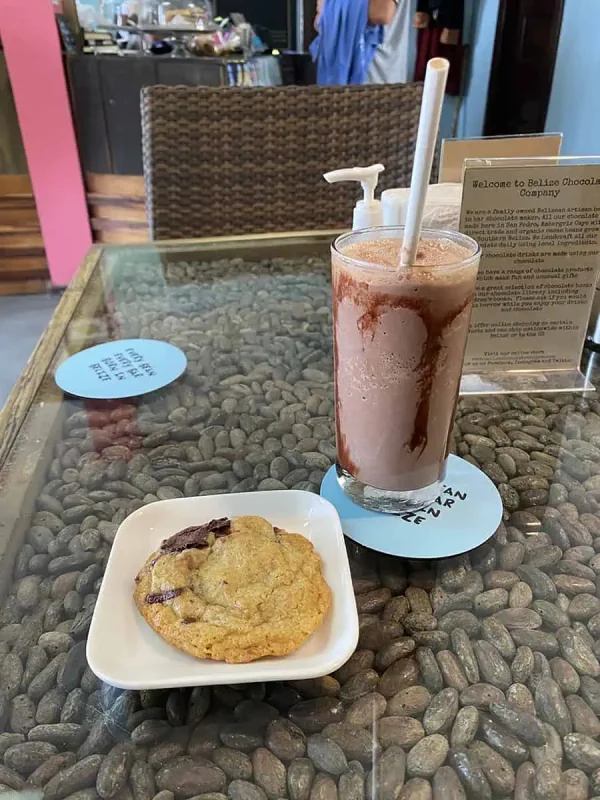 41 Best Things To Do In Ambergris Caye For The Ultimate Holiday 18 A refreshing chocolate milkshake and cookie from the Belize Chocolate Company in Ambergris Caye, inviting visitors to enjoy local treats.