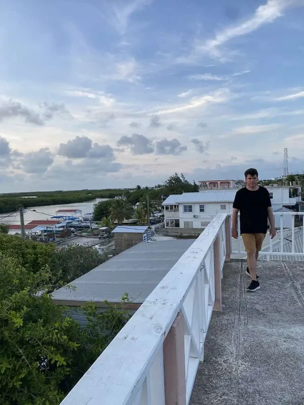 41 Best Things To Do In Ambergris Caye For The Ultimate Holiday 33 A man walking along the rooftop with a view of Ambergris Caye, providing a perspective on the laid-back island lifestyle and the simplicity of enjoying beautiful vistas.