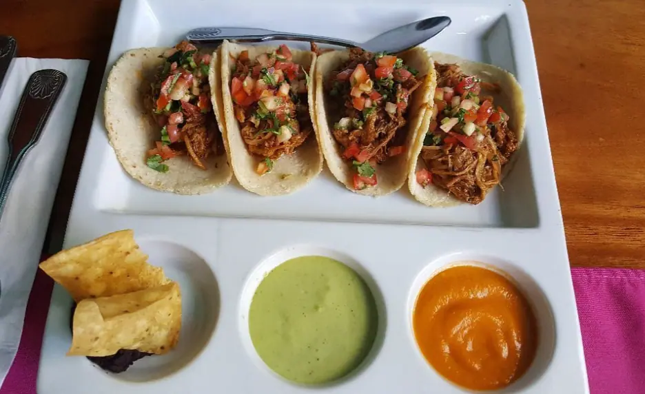41 Best Things To Do In Ambergris Caye For The Ultimate Holiday 21 Delicious and authentic Belizean tacos served with sides of guacamole and spicy sauce, representing the culinary delights that await visitors looking for the best things to do in Ambergris Caye.