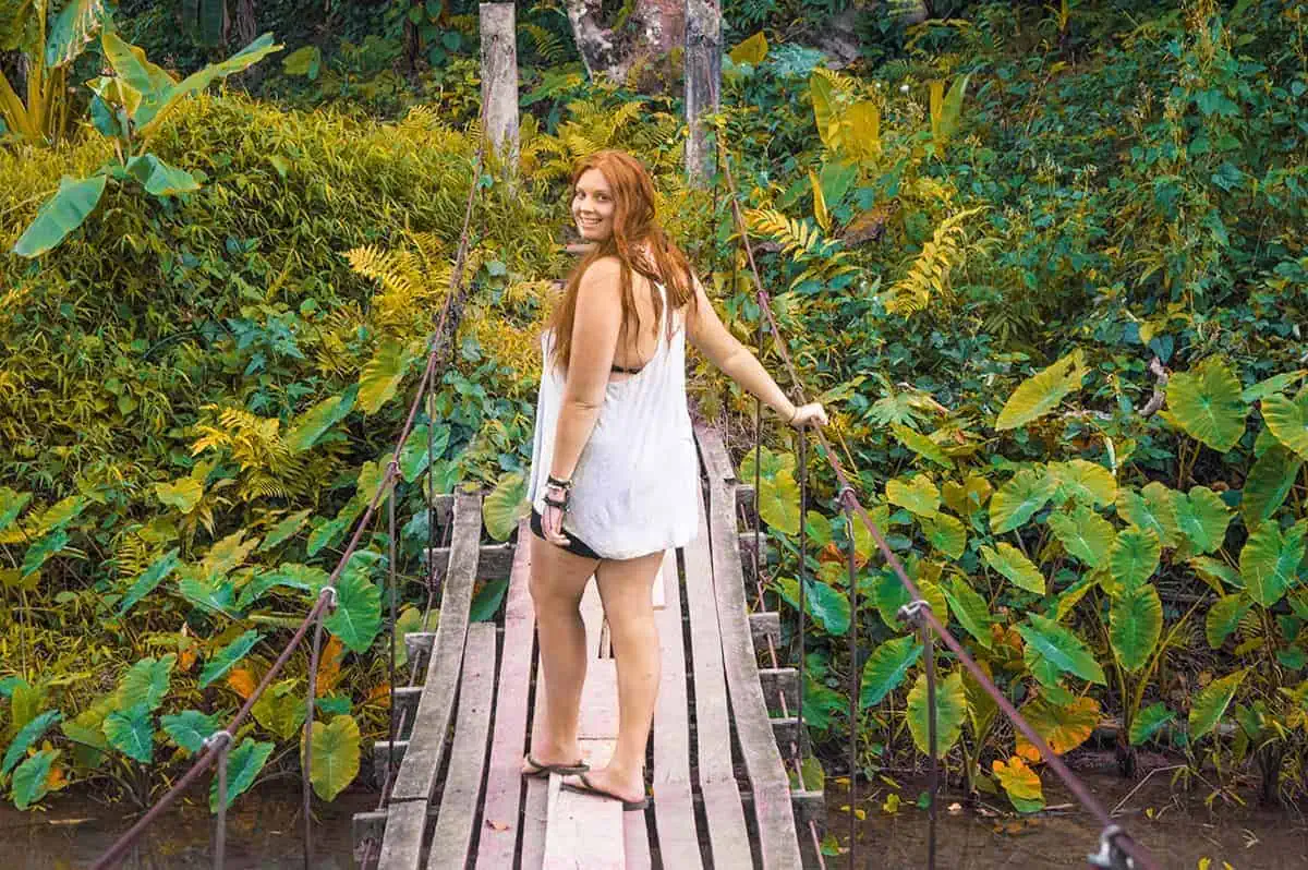 Blue Lagoon 3 In Vang Vieng: BEST Tips For Visiting 2025 9 standing on a wooden swing bridge at blue lagoon 3 in vang vieng