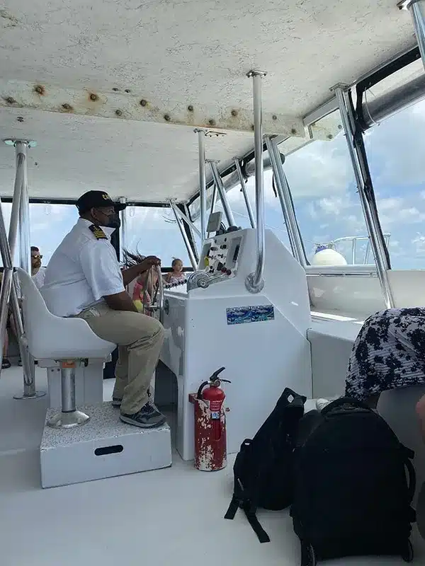 Caye Caulker To Belize City: Best & Easiest Ways 11 A group of people sitting on a boat traveling from Caye Caulker to Belize City with a captain.