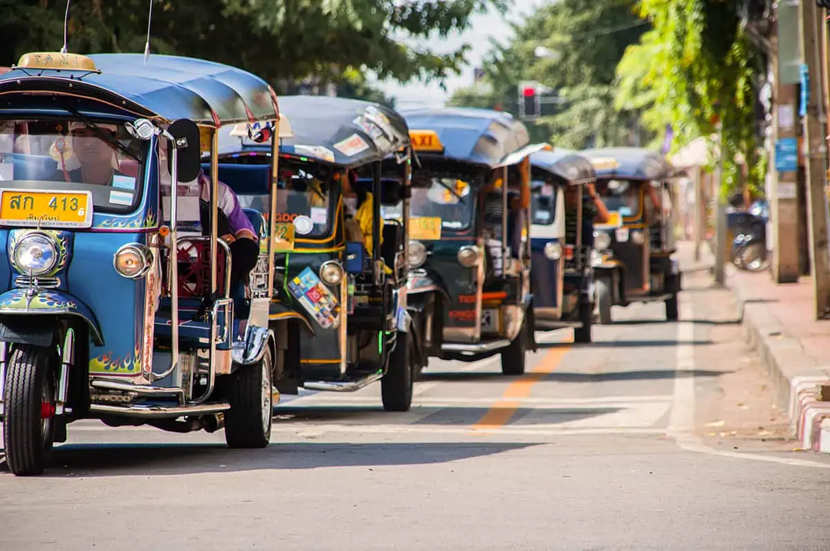 a tuk tuk convoy in the streets of chiang mai