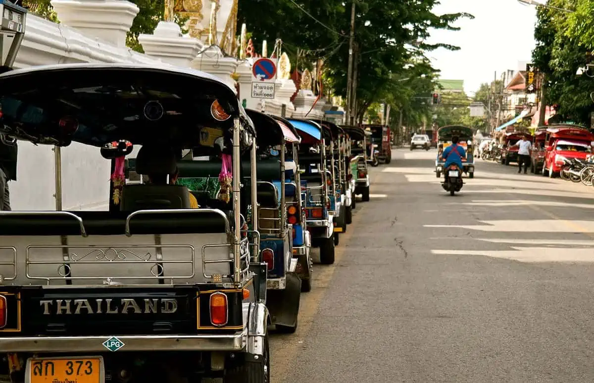 Chiang Mai Airport to City: Bus, TukTuk, Taxi, Or Walk? 11 tuk tuks lined up when traveling chiang mai airport to city