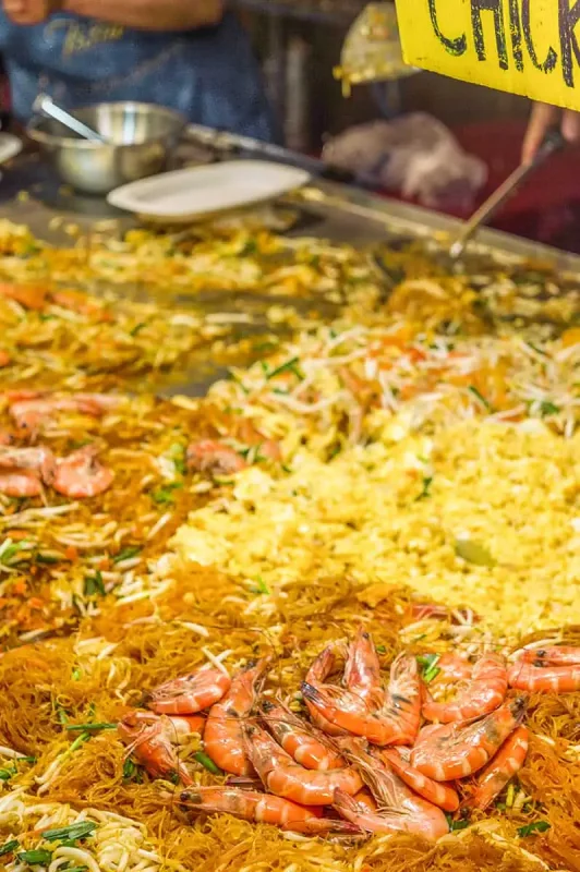 Chiang Mai Sunday Night Market: BEST Tips & Guide (2025) 7 Local vendor serving an array of traditional Thai dishes at a bustling food stall