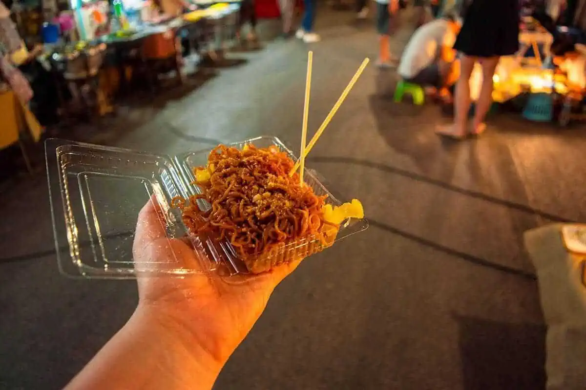 Chiang Mai Sunday Night Market: BEST Tips & Guide (2025) 20 Tasha amy with a helping of savory noodles packed in a clear takeaway container