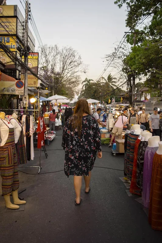 Chiang Mai Sunday Night Market: BEST Tips & Guide (2025) 26 tasha amy browsing through a selection of clothing and accessories at the fashion stalls of the Market in Chiang Mai.