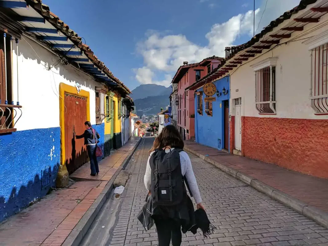 22+ Cheapest Countries To Backpack In The World! (2025) 27 A woman backpacking down a narrow street in Colombia, one of the cheapest countries to travel.