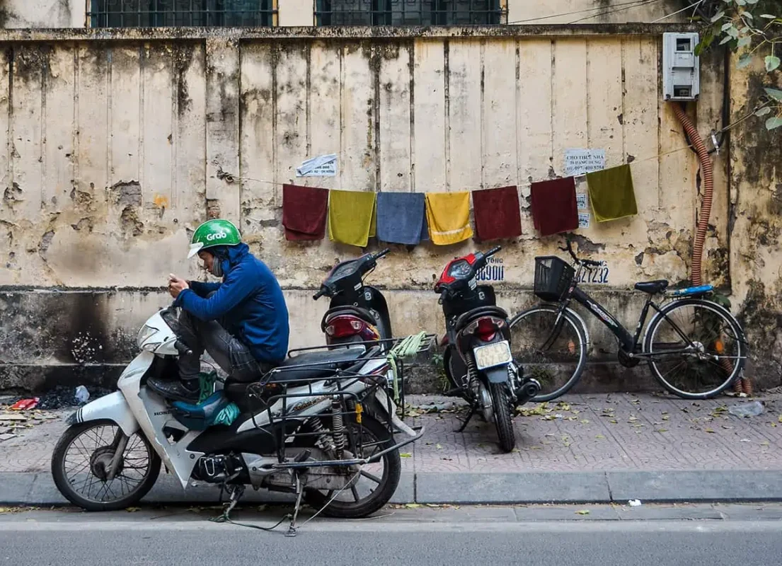 How To Travel From Da Nang To Hoi An 9 a grab driver on his phone waiting for customers in da nang