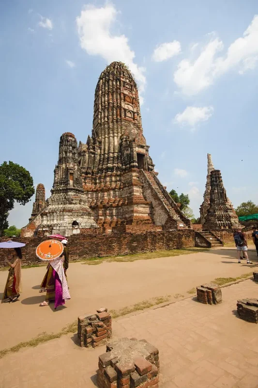 Ayutthaya Day Trip From Bangkok: BEST Guide (2025) 9 local ladies dressed in traditional clothes around Wat Chai Watthanaram prang