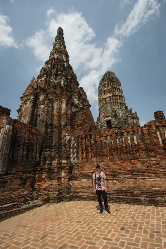 Ayutthaya Day Trip From Bangkok: BEST Guide (2025) 8 a man standing in front of Wat Chai Watthanaram