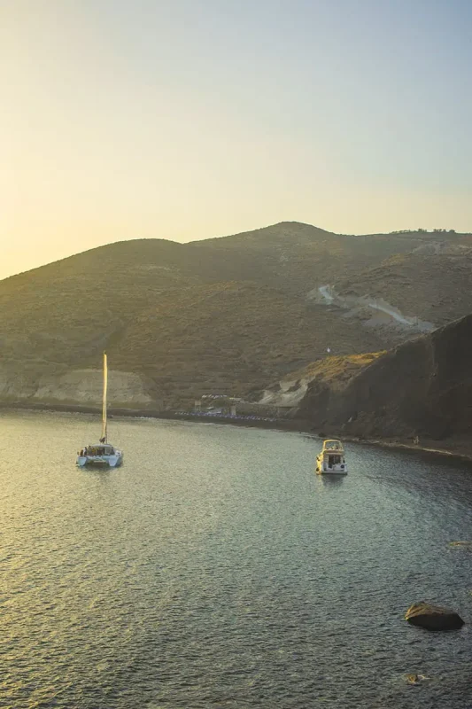 22+ Cheapest Countries To Backpack In The World! (2025) 32 A group of sailboats in the water near a hill in santorini