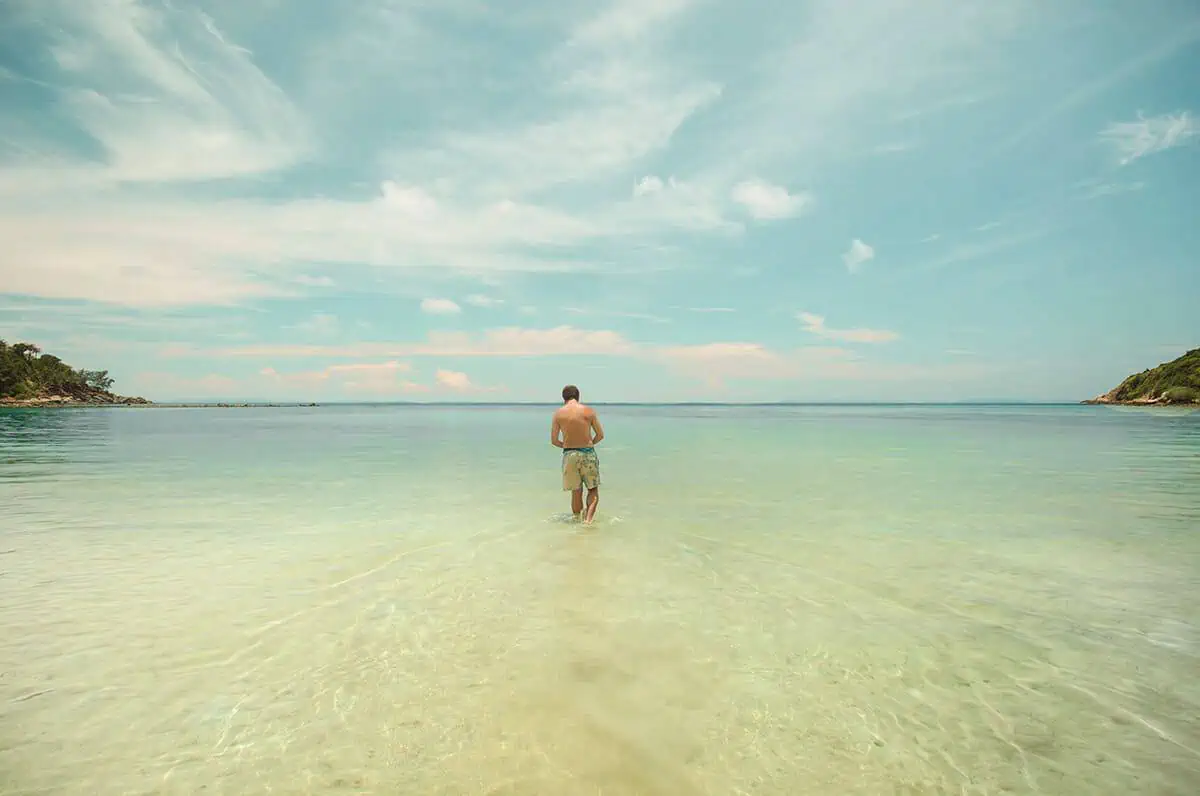walking out into the water at haad salad , one of the best beaches in koh phangan