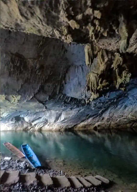 Kong Lor Cave, Laos: ULTIMATE Guide (2025) 17 wooden long tail boats at the beginning of kong lor cave waiting for tourists