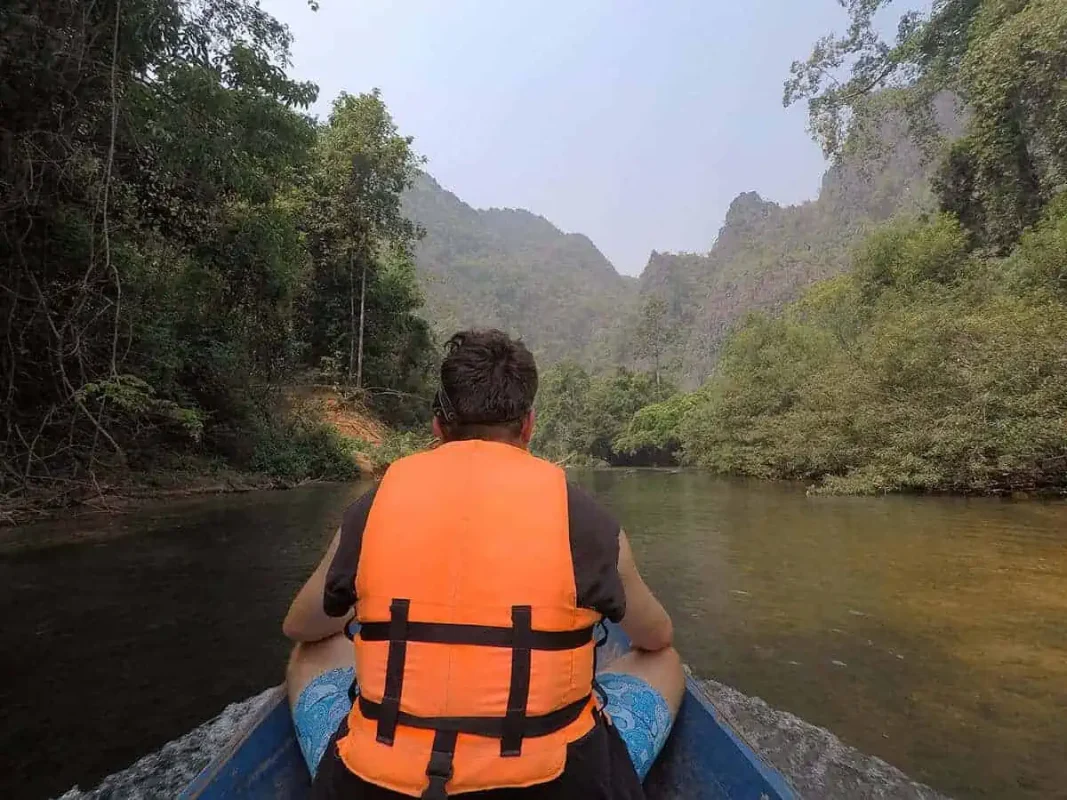 Kong Lor Cave, Laos: ULTIMATE Guide (2025) 12 taken a wooden longtail boat through the jungle in laos
