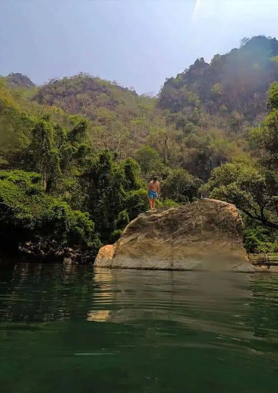 Kong Lor Cave, Laos: ULTIMATE Guide (2025) 5 jumping off rocks into river at kong lor cave