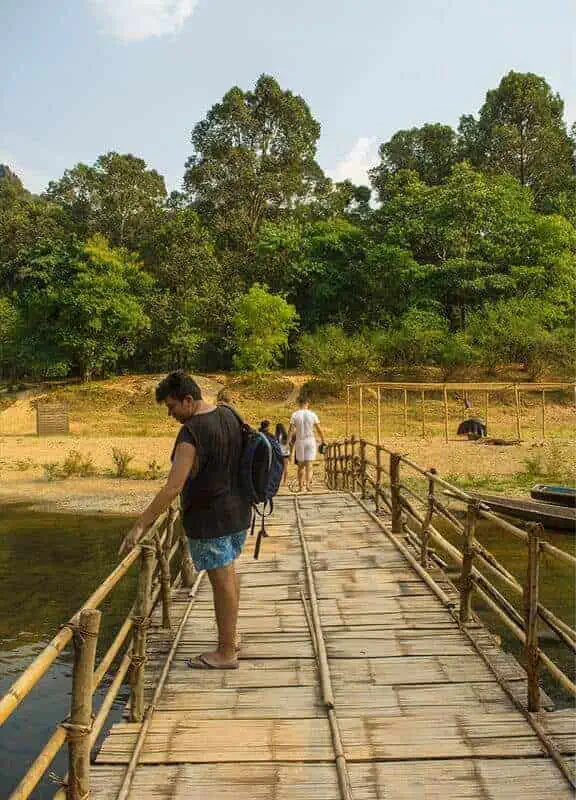 Kong Lor Cave, Laos: ULTIMATE Guide (2025) 11 walking across the bamboo bridge above the nam hin bun river