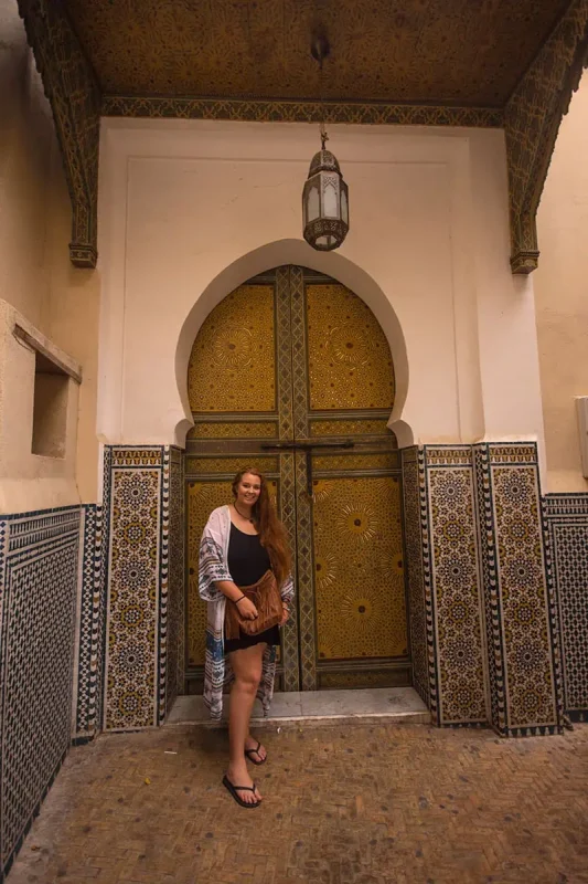 22+ Cheapest Countries To Backpack In The World! (2025) 39 tasha amy standing in front of an ornate door in fes