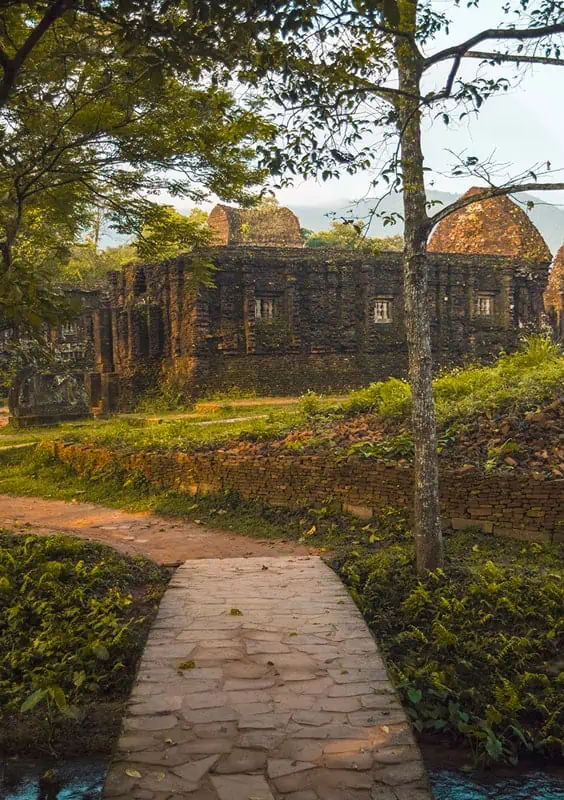 My Son Sanctuary Hoi An: BEST Tips & Tours (2025) 7 looking over at one of the temples at my son sanctuary over a stone bridge with a stream running underneath