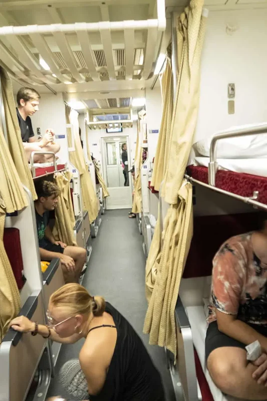 Sleeper Train Bangkok to Chiang Mai: BEST Tips 2025 13 Passengers relaxing in their berths after setting up beds for the night on the sleeper train to Chiang Mai.