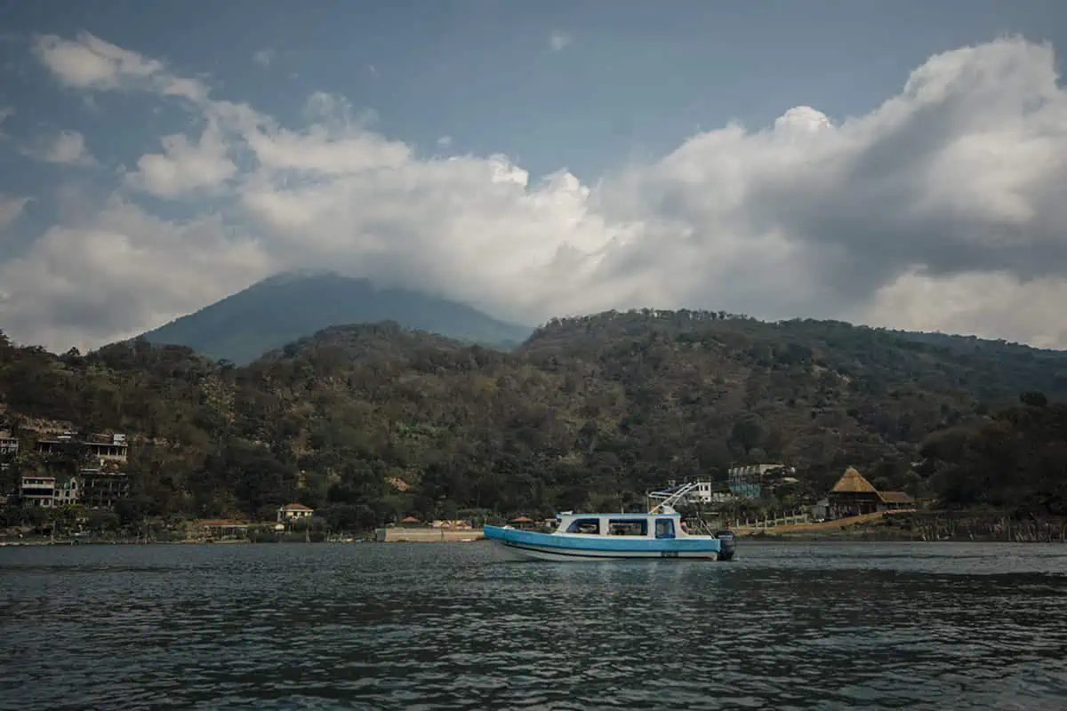 Panajachel To San Pedro & The Towns Between: How To Travel Around Lake Atitlan 35 a water taxi heading the opposite way to us while traveling around lake atitlan