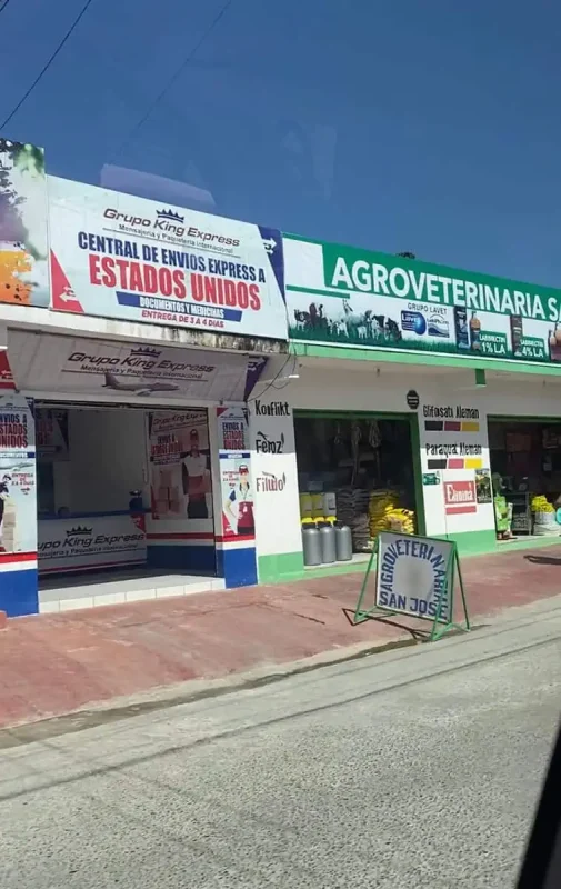 Travel San Ignacio To Flores & Crossing The Border 24 The storefront of Grupo King Express features a sign advertising 'Central de Envios Express a Estados Unidos,'at a town on the way to flores.