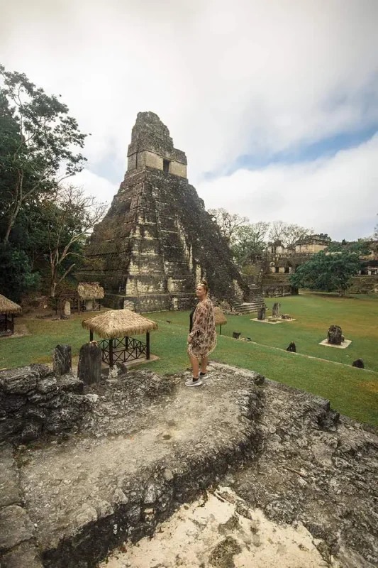 San Ignacio To Tikal & BEST Tikal Tours From San Ignacio 12 Tasha Amy standing in front of a towering temple at Tikal, evidence of the majestic Mayan architecture that can be explored on tours from San Ignacio.