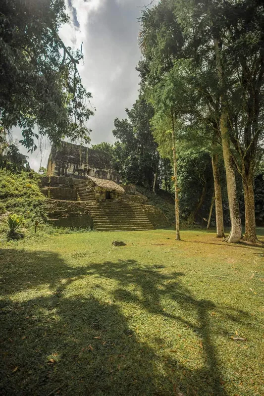 San Ignacio To Tikal & BEST Tikal Tours From San Ignacio 13 A secluded ancient structure at Tikal enveloped in the jungle ambiance, captured during a serene moment on a tour from San Ignacio.