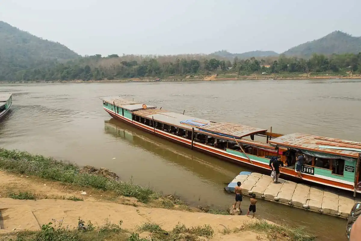 Taking The Slow Boat To Luang Prabang: BEST Tips 2025 20 Boats moored up at Luang Prabang with passengers disembarking.