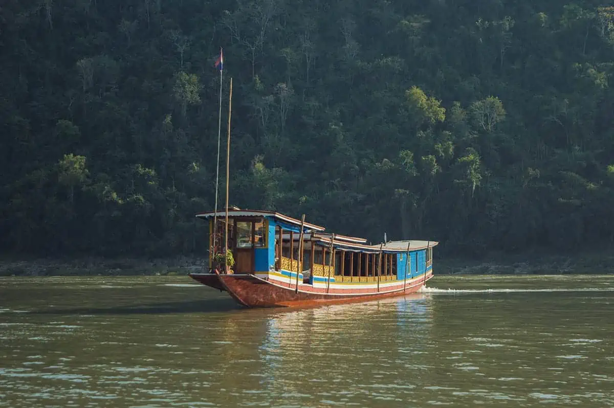 Taking The Slow Boat To Luang Prabang: BEST Tips 2025 22 A slow boat to Luang Prabang gliding along the Mekong River