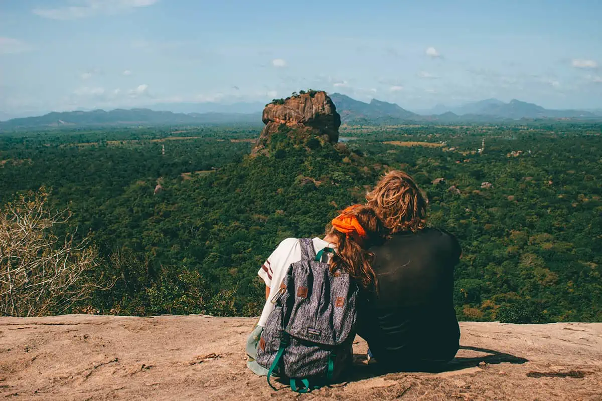 22+ Cheapest Countries To Backpack In The World! (2025) 1 Two people sitting on top of a rock overlooking sri lanka.