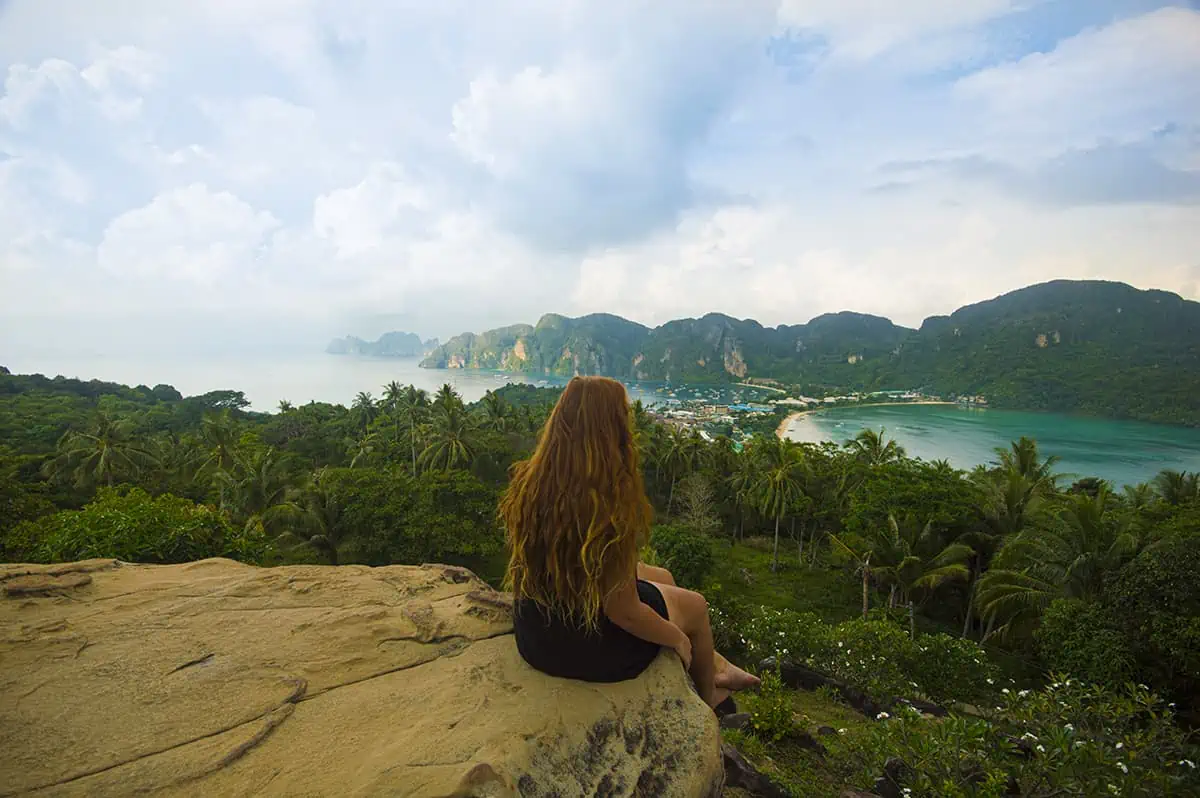 22+ Cheapest Countries To Backpack In The World! (2025) 11 tasha amy enjoys the scenic view atop a rock overlooking the ocean in a backpacker-friendly country of thailand