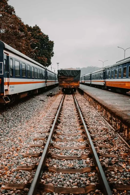 Vietnam Sleeper Train Ultimate Guide For Tourists (2025) 5 Railway tracks paving the way to a stationary Vietnam sleeper train awaiting departure