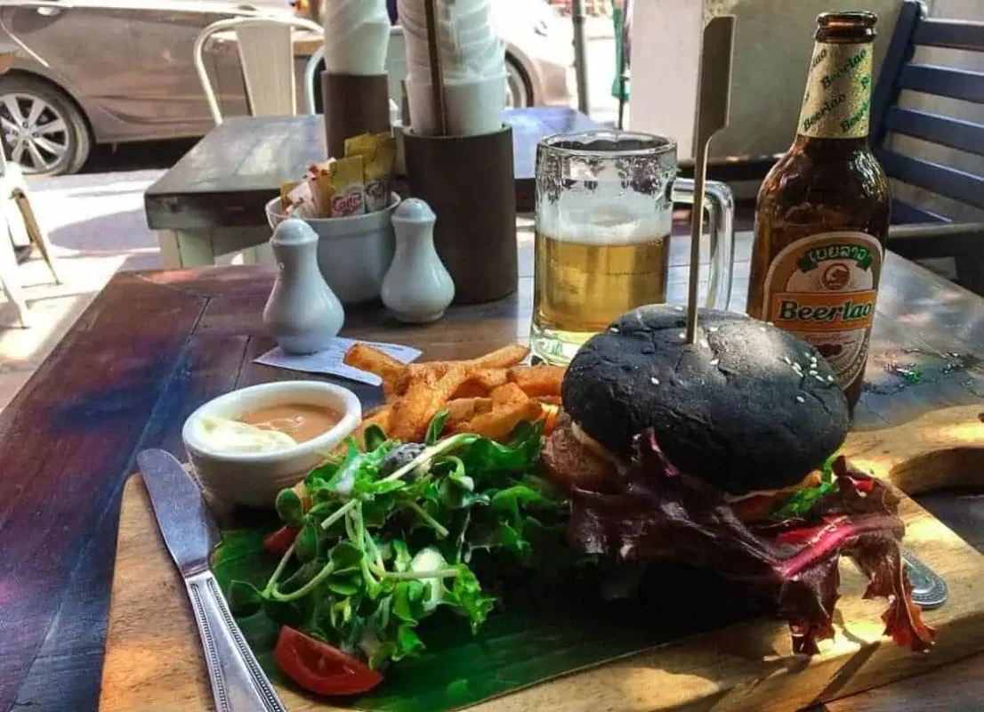 Where To Eat In Luang Prabang: 12 BEST Restaurants 2025 11 charcoal burger and fries from indigo cafe in luang prabang