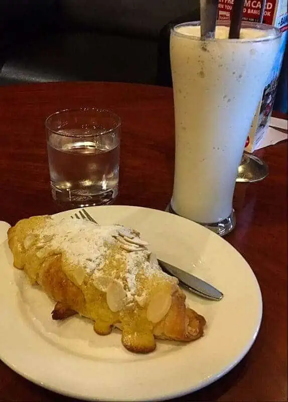 Where To Eat In Luang Prabang: 12 BEST Restaurants 2025 4 almond croissant and smoothie from joma cafe, one of the best bakeries in luang prabang