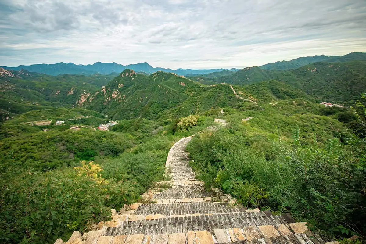 120+ Would You Rather Travel Questions For Ultimate Wanderers 1 A rugged section of the Great Wall of China stretches through green hills, with distant mountain peaks, this location should definitely be considered for the would you rather travel questions